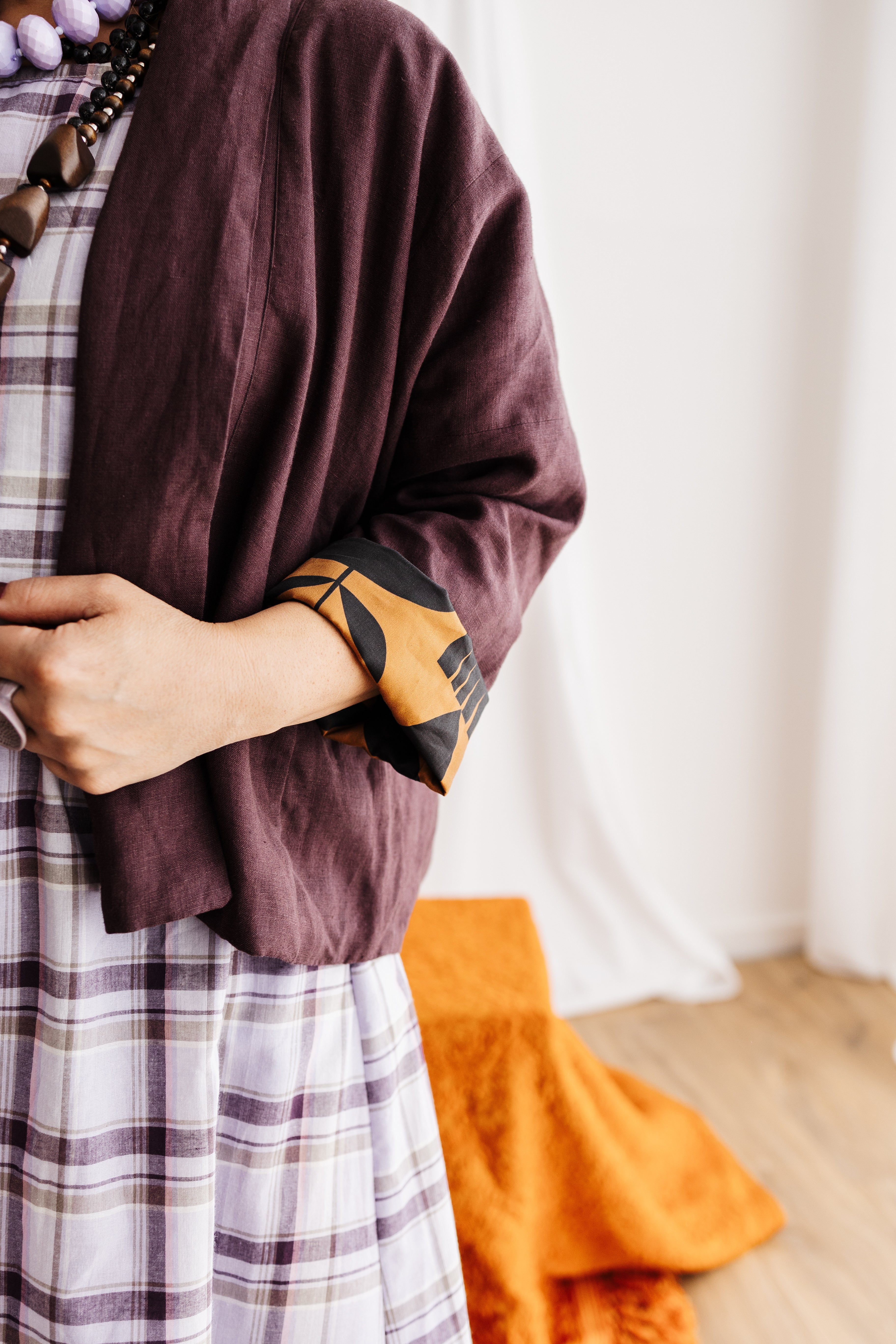 A reversible linen jacket — two looks in one. Butterscotch Memento print by Cecilia Mok and rich aubergine linen. Handmade in the Dandenong Ranges, Australia.