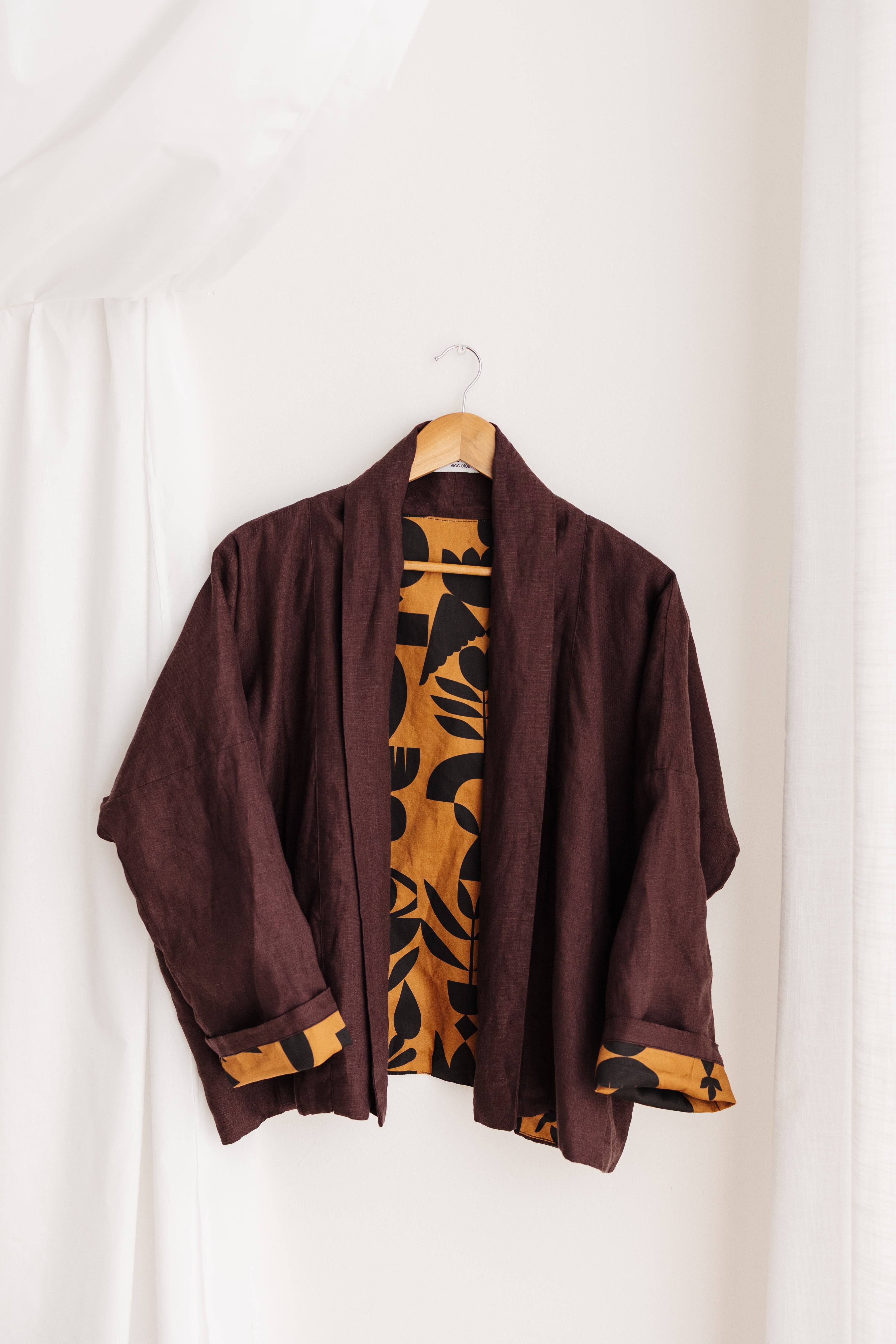 A reversible linen jacket — two looks in one. Butterscotch Memento print by Cecilia Mok and rich aubergine linen. Handmade in the Dandenong Ranges, Australia.
