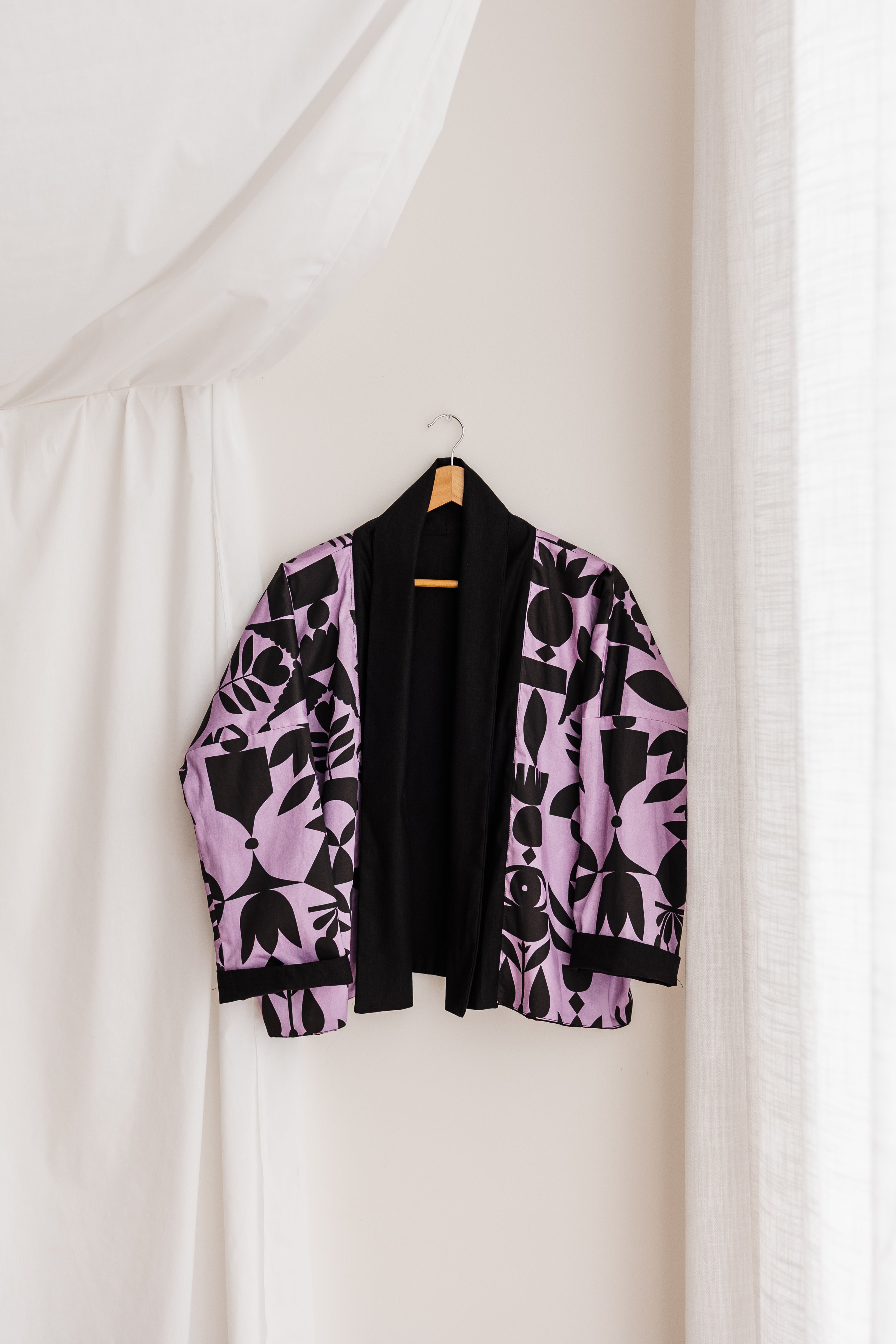 A reversible linen jacket — two looks in one. Lilac Memento print by Cecilia Mok and classic black linen. Handmade slow fashion from the Dandenong Ranges, Australia.