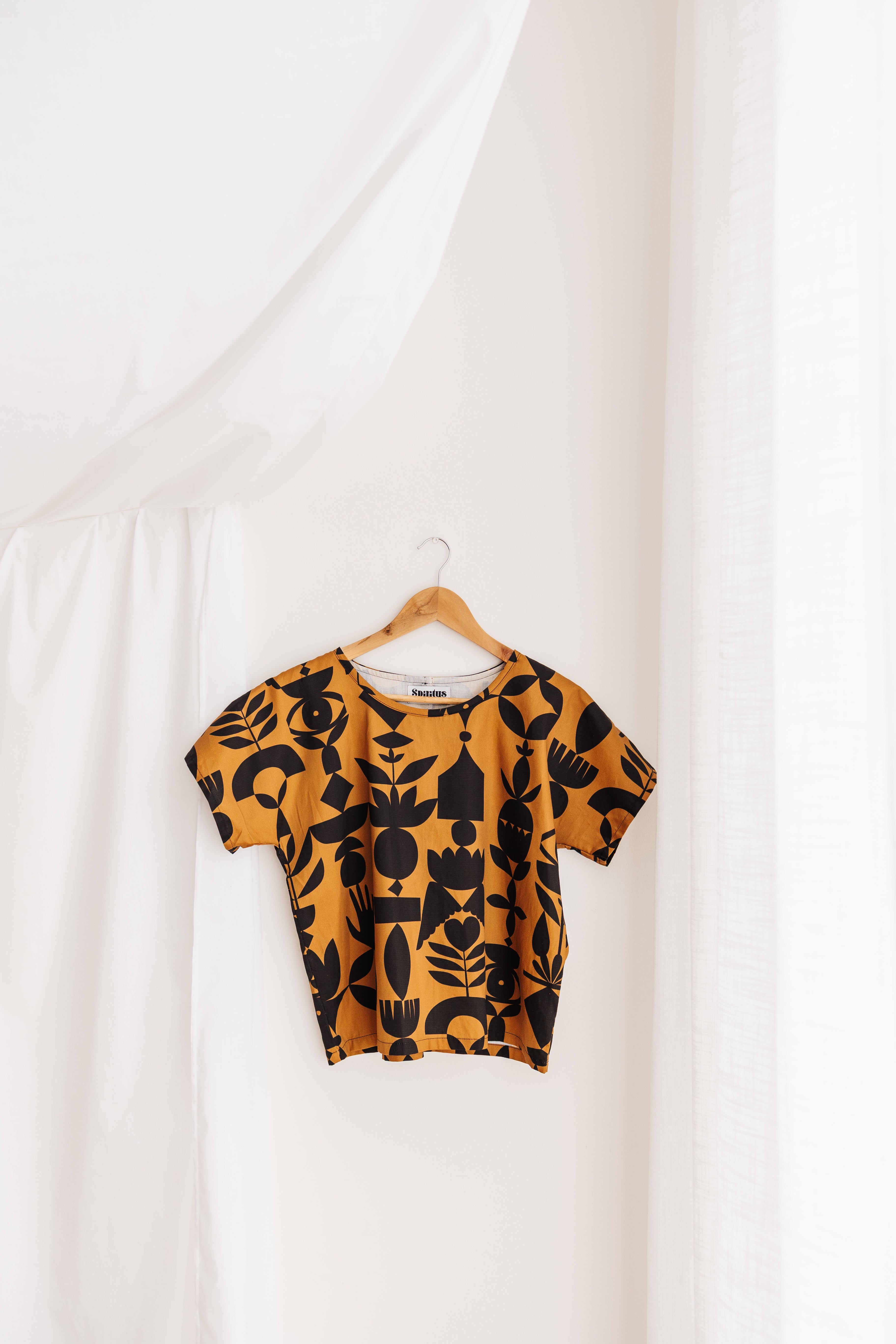 A relaxed tee in warm butterscotch featuring the Memento print by Cecilia Mok. Made to order in organic cotton. Future Vintage by Spiritus Eco Clothing.